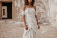 21 a beautiful sheath wedding gown featuring long fringe and lace arm band sleeves