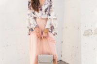 21 a blush ruffled asymmetrical midi, a floral blouse with bell sleeves, neutral shoes and a grey bag