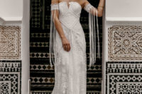 23 boho lace wedding dress with a textural bodice, a train and lace arm band sleeves with long fringe