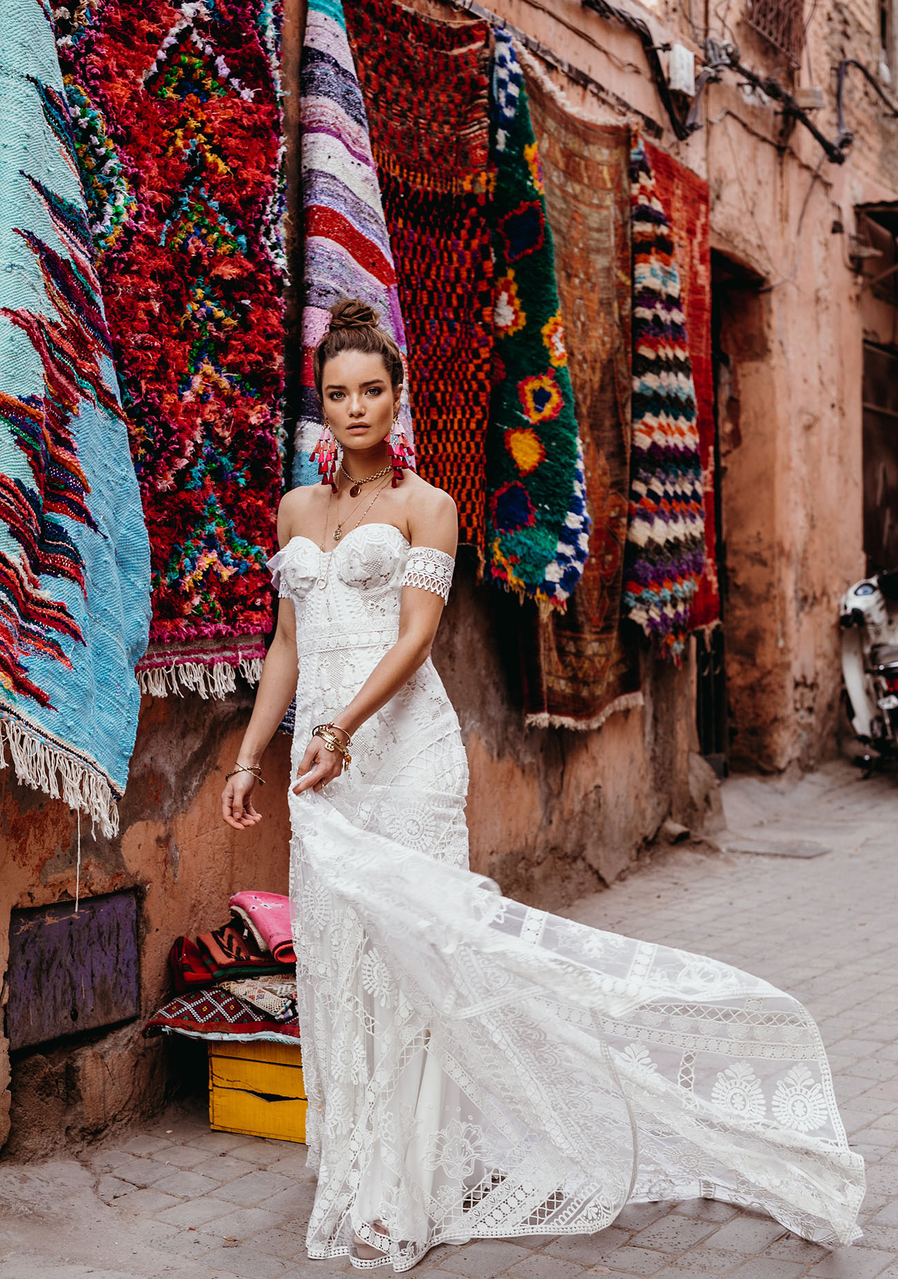 boho lace wedding gown, with a strapless neckline, a sheath silhouette, a train and arm lace bracelets