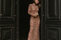 25 a nude maxi beaded and embroidered wedding guest dress with long sleeves and a metallic clutch