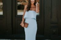26 a powder blue strapless midi dress with a layered bodice, nude heels and a brown clutch