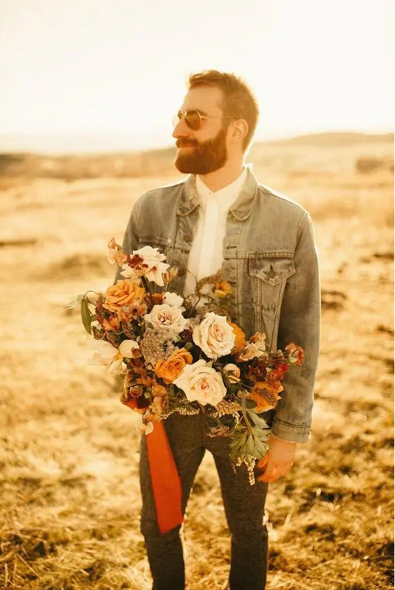 a relaxed groom's outfit with a white shirt, grey pants, a bleached denim jacket and sunglasses is a lovely and cool idea