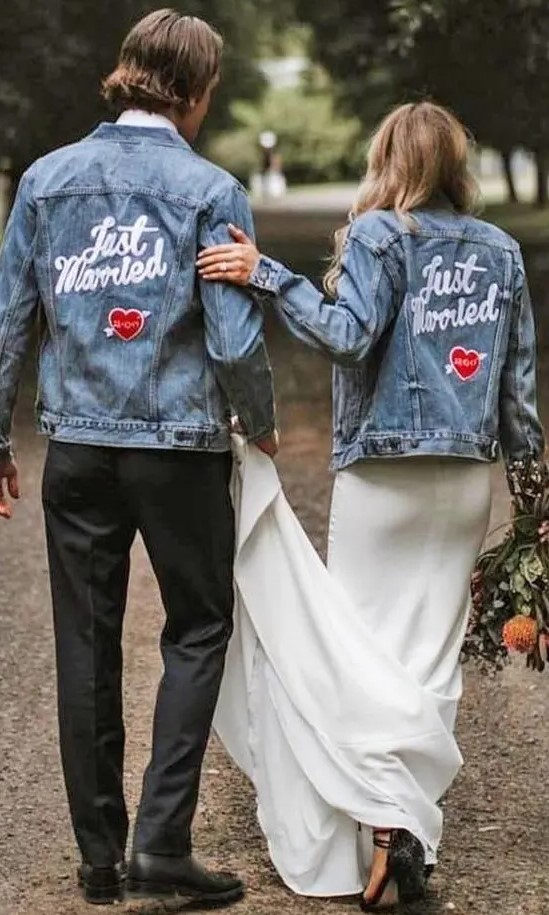 matching blue denim jackets with white calligraphy and hearts with the wedding date is a cool and chic idea