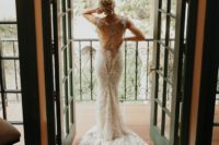 02 The bride was wearing a fantastic lace mermaid wedding dress with a cutout back with chains and embellishments and a train