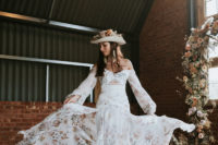 02 The first wedding dress was a floral off the shoulder one with lace inserts, tassel earrings and a floral hat completed the look