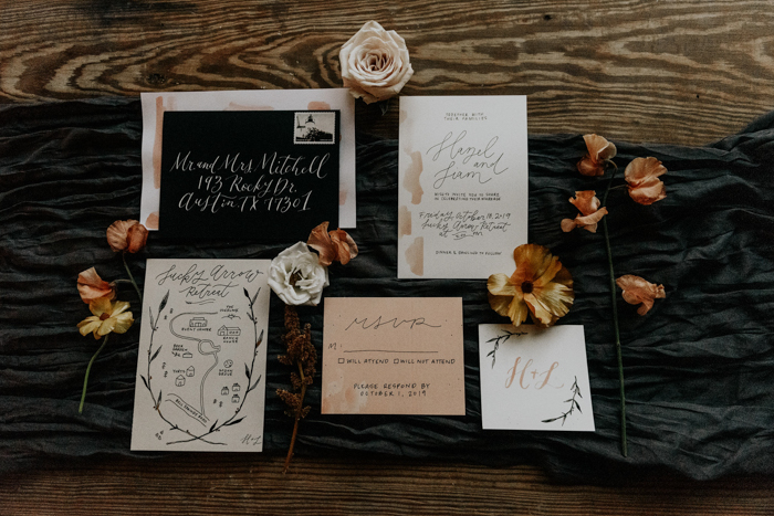 The wedding invitation suite was done in black, white and earthy tones, with calligraphy and a hand painted map