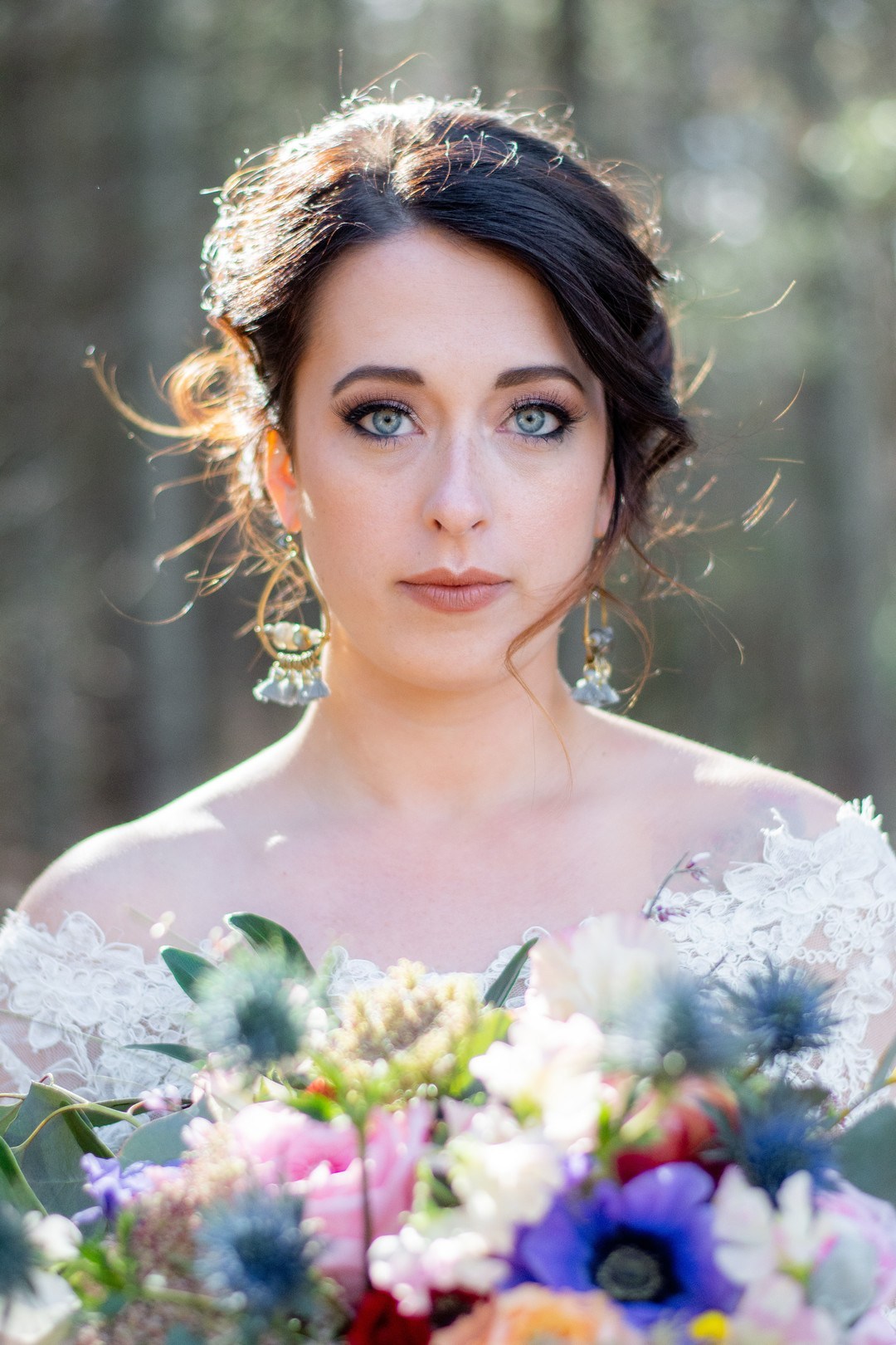 The bride was rocking blue statement earrings with tassels that matched her eyes