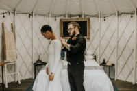03 The bride was wearing a plain mermaid wedding gown with long sleeves and a train, the groom was wearing black pants, a button up and shoes
