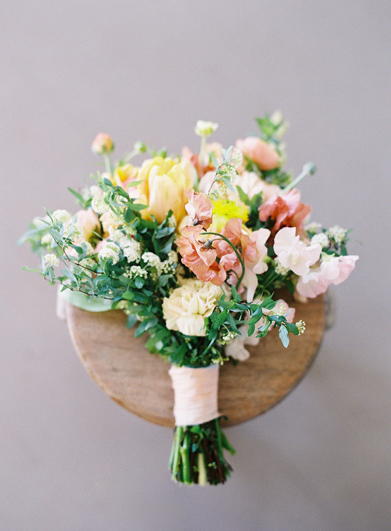 The bright wedding bouquet was inspired by the islands and was done in red, blush and yellow tones