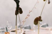 03 gold pipes on stands with very dark calla lilies are a minimalist and moody centerpieces that look really wow