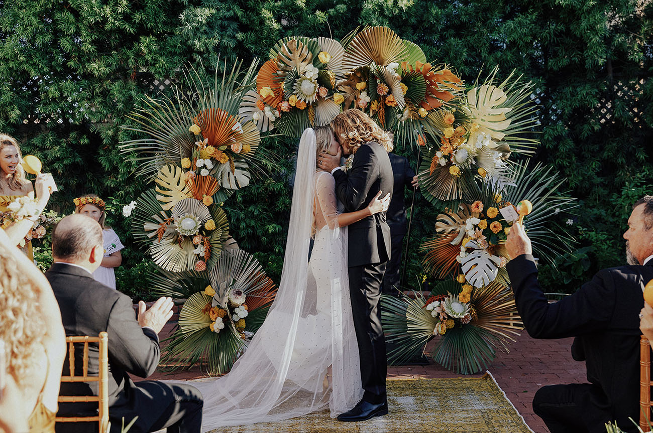 The wedding arch was done with king proteas and tropical leaves, usual and spray painted