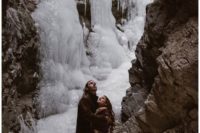 04 a frozen waterfall is a fantastic place to tie the knot, it looks like an ice fairytale