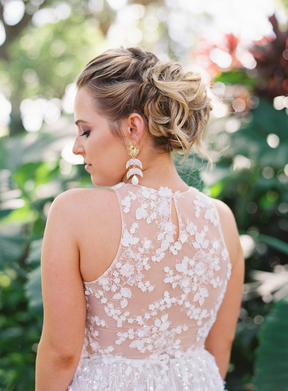A wavy updo and statement earrings were a perfect fit for the chic dress