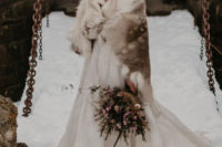 05 Daenerys-styled bride in a lace wedding ballgown, with a braided hairstyle and a fur coverup