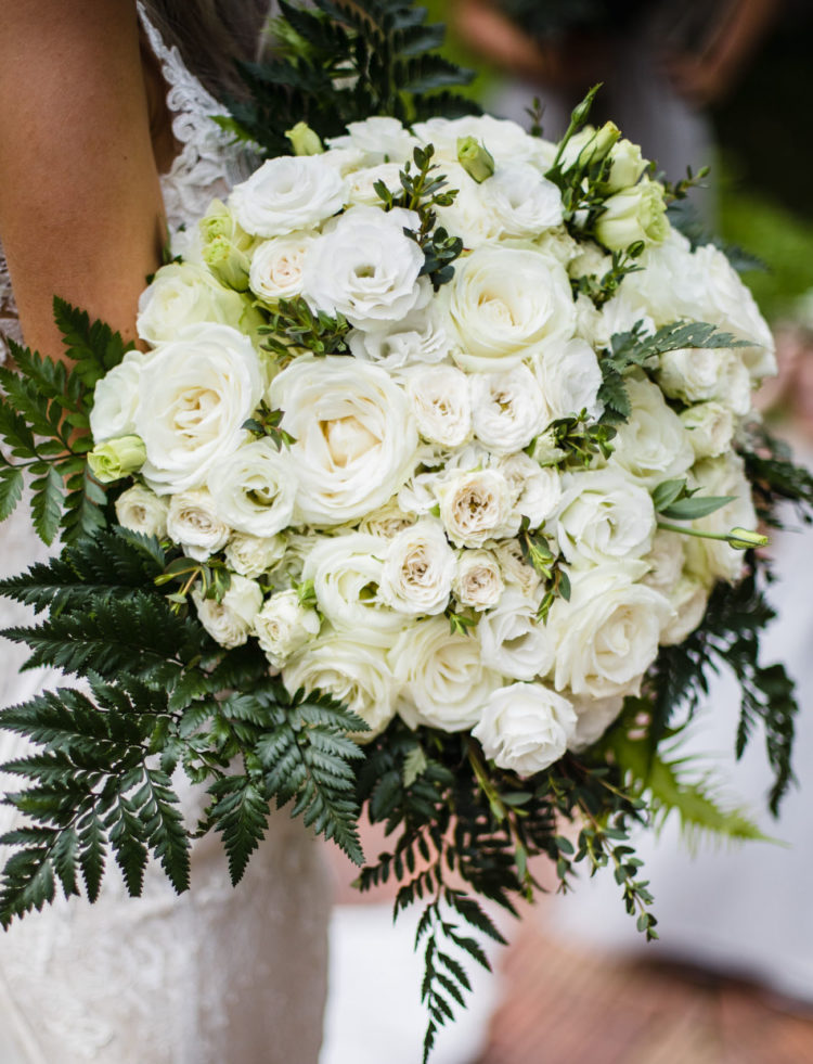 The bouquets were white and styled with greenery