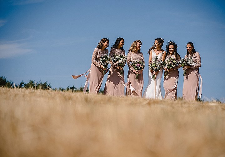 The bridesmaids were wearing dusty pink maxi dresses with lace bodices and plain skirts