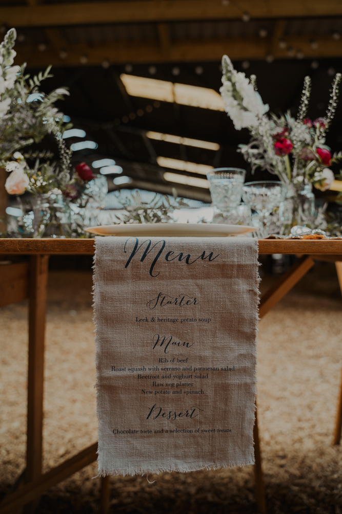 The wedding table runner was a linen one with a menu printed on it