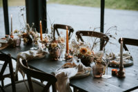 08 The wedding tablescape was done in earthy tones, with rust candles, dried herbs and blooms, colored glasses and neutral napkins