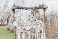 08 a rustic boho wedding backdrop made up of macrame dreamcatchers, greenery and candles around