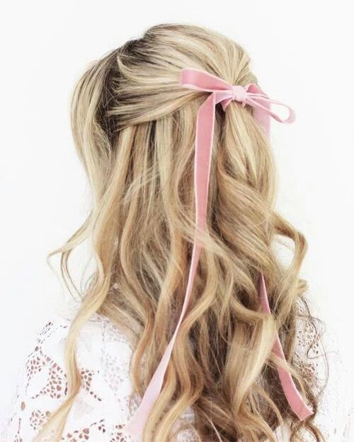 a wavy half updo with a pink velvet ribbon bow for an accent is a very girlish and sweet idea for a bride