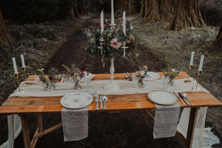 The wedding tablescape was done with an ethereal runner, floral plates, greneery and blooms, a candelabra decorated with florals