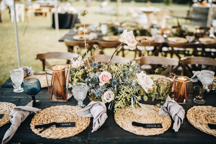 Wicker placemats, lush floral centerpieces, copper candles and neutral napkins created a cool boho look