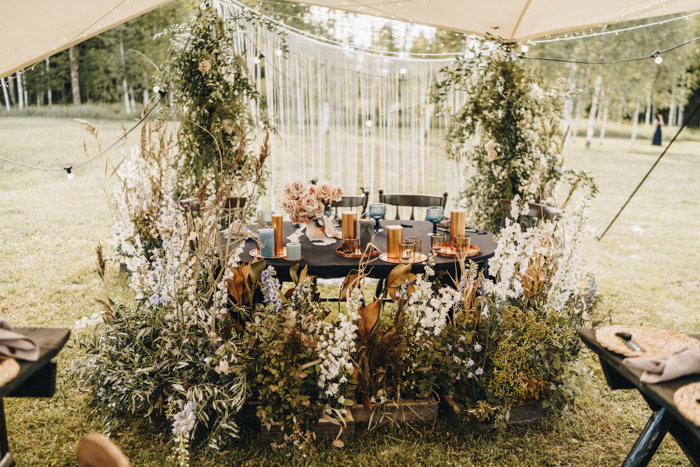 The sweetheart table was all surrounded with dried foliage, greenery and white blooms