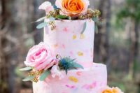 10 The wedding cake was a pink one, with watercolor brushstrokes in bold colors and gold leaf plus bright blooms and thistles