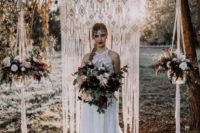 10 a macrame wedding backdrop with potted blooms hanging on each side of the backdrop