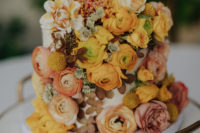 11 The wedding cake was very whimsy, it was all covered with yellow and rust blooms plus a calligraphy topper