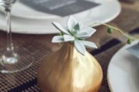 13 a pear-shaped gilded vase with a single pale succulent is a stylish and simple minimalist wedding centerpiece