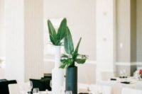 14 a black and white vase with tropical leaves is a chic and bold idea for a minimalist tropical wedding