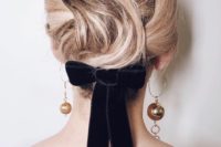 14 a wavy short hairstyle highlighted with a black velvet ribbon bow and statement mismatching earrings