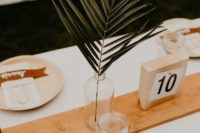 15 a bottle with a single tropical leaf is an easy and budget-friendly option of a minimalist centerpiece