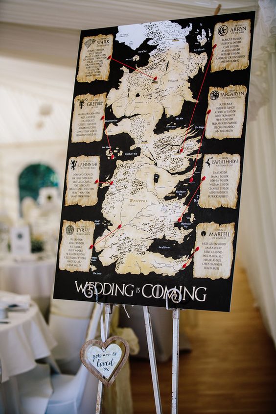 a wedding seating chart with traditional prints and the map of the GOTH world is a gorgeous idea