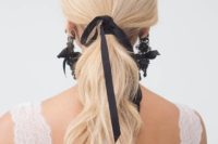 19 a wavy ponytail with a black ribbon and matching black lace and ribbon earrings by Marchesa