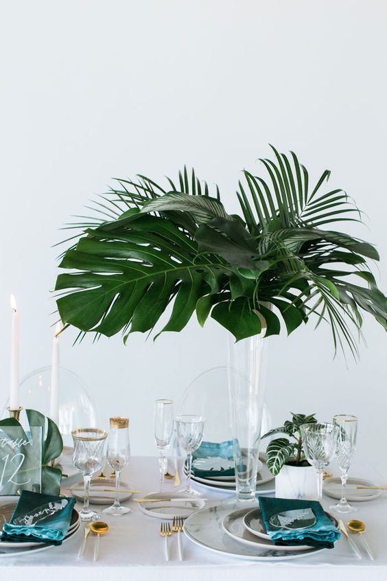 a minimalist tall wedding centerpiece with a tropical vibe