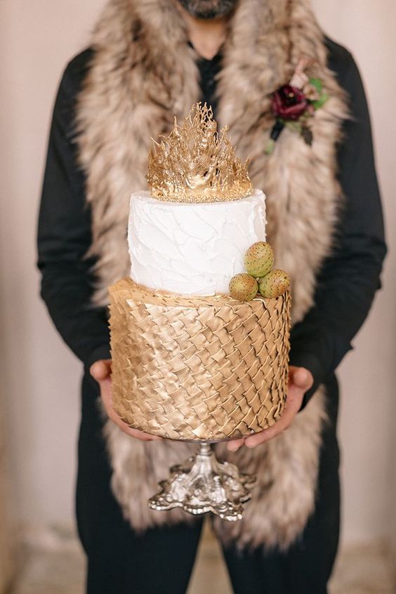 a chic GOTH wedding cake with gold scale, a white textural tier and a gold crown on top plus edible dragon eggs