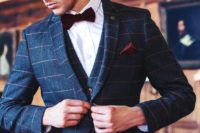 21 a navy windowpane print three-piece suit, a white shirt, a burgundy velvet bow tie and a matching handkerchief