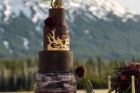 22 a cool GOTH wedding cake with matte and watercolor tiers, burgundy blooms and a dragon topper