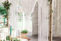 23 a simple and chic macrame wedding arch with some greenery on each corner is a cool idea
