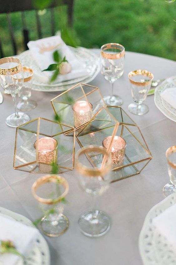 a minimalist wedding centerpiece made of geometric gilded terrariums with candle holders inside is a chic and bold idea