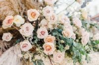 a beautiful natural blush pink roses arrangement with full greenery, lunaria and pampas grass looks unique