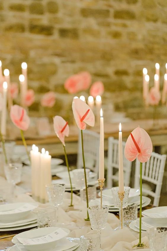 a chic wedding tablescape with single anthurium centerpieces and tall and thin candles is adorable for a wedding