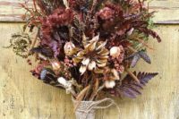 a colorful fall wedding bouquet with dried herbs, blooms, wheat, greenery and a burlap wrap for a rustic feel