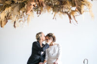 a jaw-dropping wedding ceremony installation fully of dried herbs, leaves, blooms, branches and other stuff to make a statement
