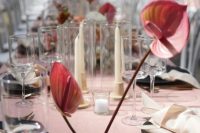 a minimalist wedding centerpiece of a plate with pink anthurium is a cool idea for a bold wedding