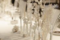 gorgeous minimalist white wedding centerpieces of bud vases and white blooms and leaves are amazing for white weddings