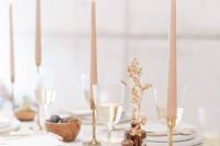 minimalist wedding centerpieces of mini vases with dried blooms and tall and thin blush candles